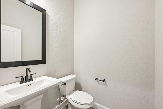 18314 Pedernales Springs Dr, Cypress, TX 77433 - bathroom featuring baseboards and a textured wall