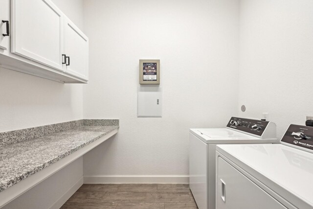 18314 Pedernales Springs Dr, Cypress, TX 77433 - laundry area featuring washer and clothes dryer, wood finished floors, cabinet space, and an office area