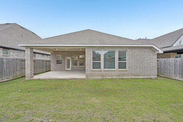 18314 Pedernales Springs Dr, Cypress, TX 77433 - back of property featuring brick siding, a fenced backyard, a patio area, and a shingled roof