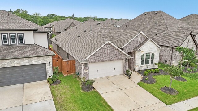18314 Pedernales Springs Dr, Cypress, TX 77433 - french country inspired facade with brick siding, driveway, a shingled roof, and stone siding