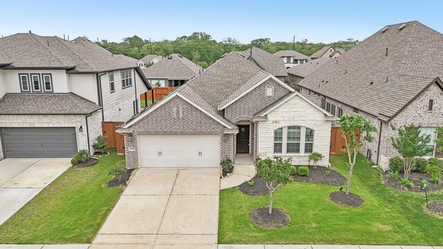 18314 Pedernales Springs Dr, Cypress, TX 77433 - french country inspired facade featuring brick siding, driveway, stone siding, and a residential view