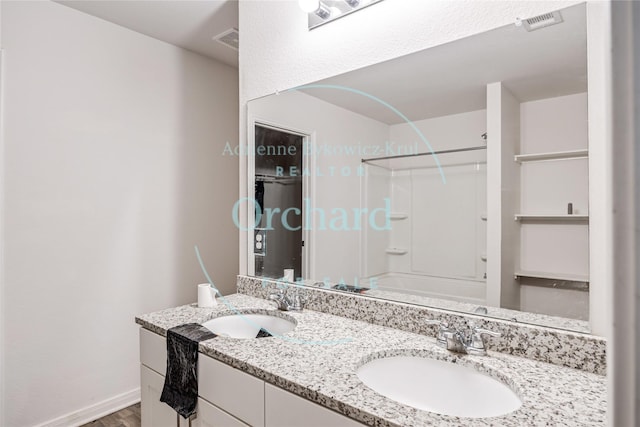 15689 Del Norte Dr, Conroe, TX 77306 - full bath featuring double vanity, shower / bathtub combination, and wood finished floors