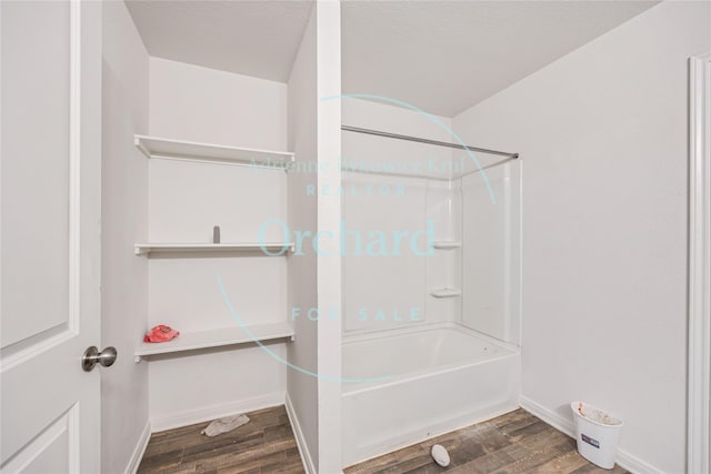 15689 Del Norte Dr, Conroe, TX 77306 - bathroom with wood finished floors and tub / shower combination