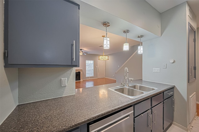 4001 Tanglewilde St Unit 1402, Houston, TX 77063 - kitchen featuring dishwasher, dark countertops, ceiling fan, hanging light fixtures, and a fireplace