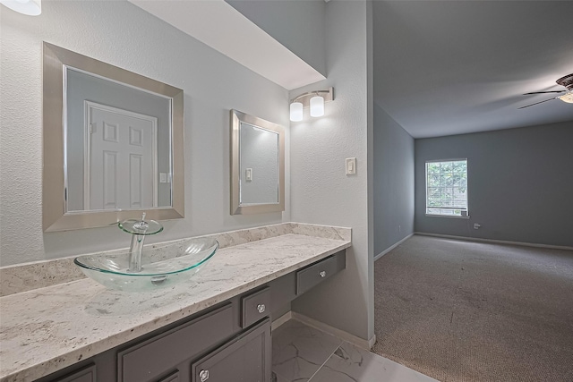 4001 Tanglewilde St Unit 1402, Houston, TX 77063 - bathroom featuring vanity, a ceiling fan, and marble look tile flooring