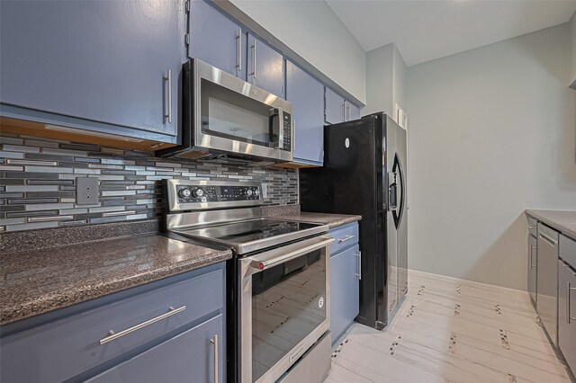 4001 Tanglewilde St Unit 1402, Houston, TX 77063 - kitchen with appliances with stainless steel finishes, backsplash, dark countertops, and blue cabinets