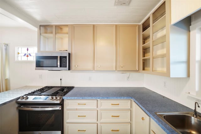 13318 Southshore Dr, Conroe, TX 77304 - kitchen with stainless steel appliances, open shelves, cream cabinets, and dark countertops