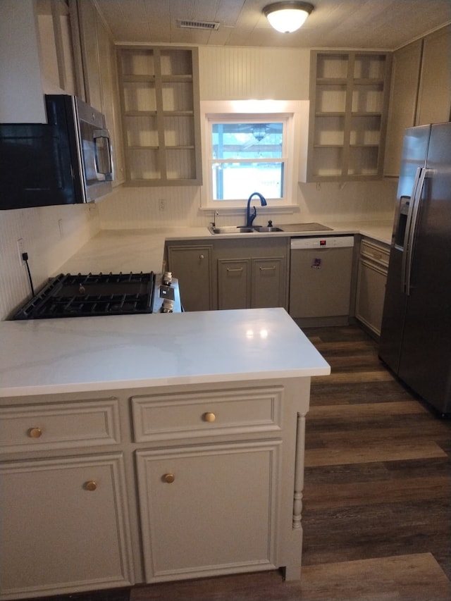 13318 Southshore Dr, Conroe, TX 77304 - kitchen with stainless steel fridge with ice dispenser, white dishwasher, black microwave, open shelves, and light countertops