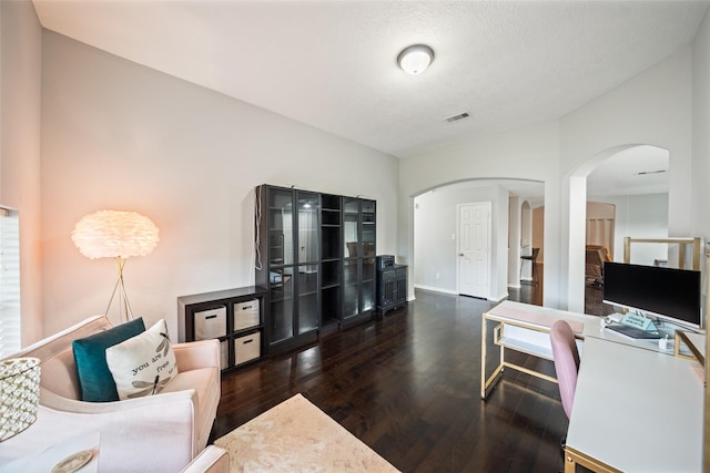 5726 Straight Way, Houston, TX 77339 - living area featuring arched walkways, wood finished floors, and vaulted ceiling