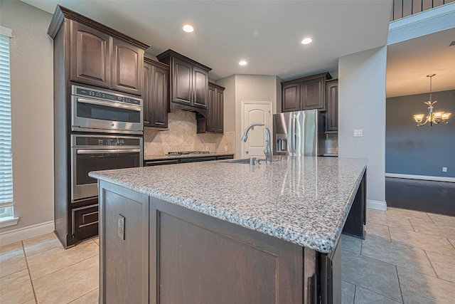 10022 Foggy Riv, Missouri City, TX 77459 - kitchen with stainless steel appliances, dark brown cabinets, backsplash, a chandelier, and recessed lighting