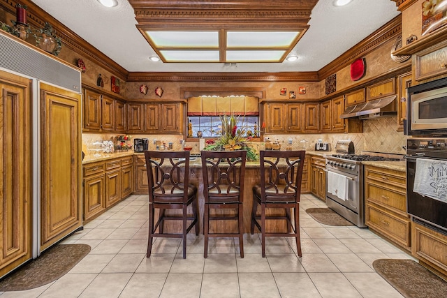 1454 Oday, Pearland, TX 77581 - kitchen featuring built in appliances, under cabinet range hood, backsplash, light tile patterned flooring, and crown molding