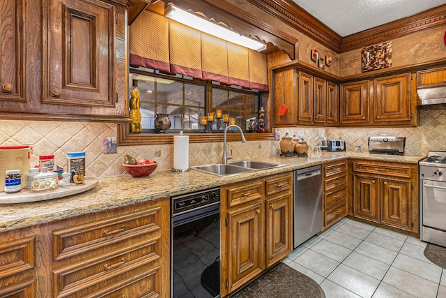 1454 Oday, Pearland, TX 77581 - kitchen with stainless steel appliances, tasteful backsplash, brown cabinets, light tile patterned flooring, and under cabinet range hood