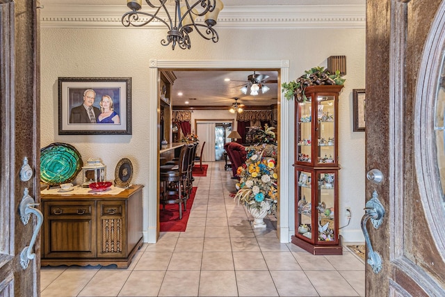 1454 Oday, Pearland, TX 77581 - entrance foyer with ornamental molding, light tile patterned flooring, ceiling fan, a textured wall, and a chandelier