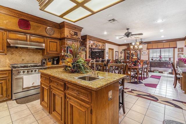 1454 Oday, Pearland, TX 77581 - kitchen featuring stainless steel gas range oven, range hood, light tile patterned floors, decorative backsplash, and crown molding
