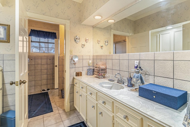 1454 Oday, Pearland, TX 77581 - bathroom featuring wallpapered walls, tile patterned floors, vanity, tile walls, and wainscoting
