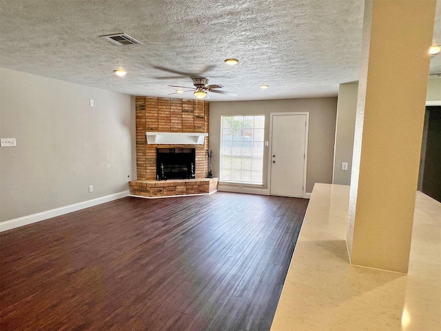415 Sevenhampton Ln, Houston, TX 77015 - unfurnished living room featuring ceiling fan, wood finished floors, a fireplace, and a textured ceiling