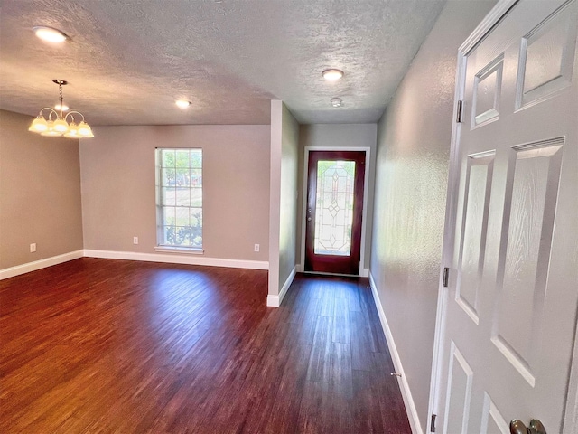 415 Sevenhampton Ln, Houston, TX 77015 - foyer entrance with dark wood-style floors, a textured ceiling, and a chandelier