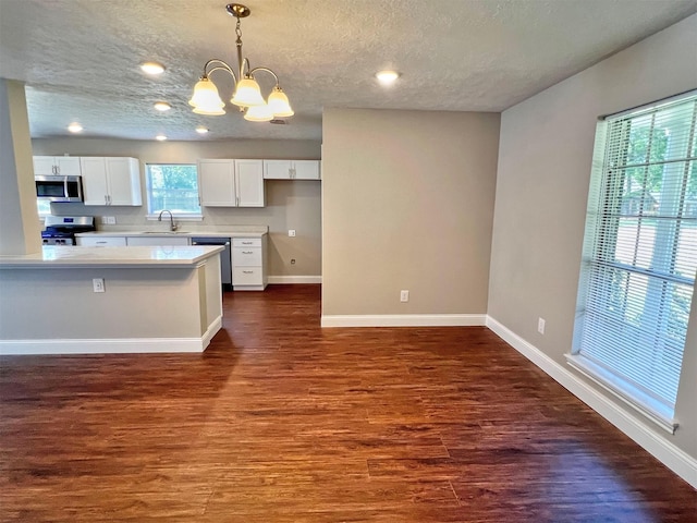 415 Sevenhampton Ln, Houston, TX 77015 - kitchen featuring appliances with stainless steel finishes, a chandelier, a textured ceiling, white cabinetry, and light countertops