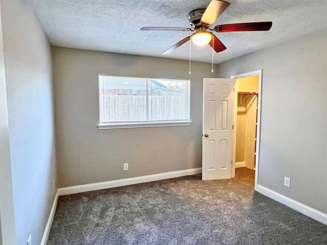 415 Sevenhampton Ln, Houston, TX 77015 - unfurnished bedroom with a textured ceiling, carpet flooring, a spacious closet, a ceiling fan, and a closet
