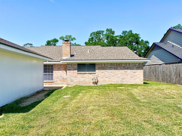 415 Sevenhampton Ln, Houston, TX 77015 - back of house with a chimney, brick siding, and roof with shingles
