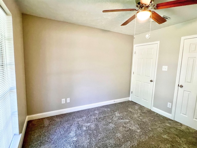 415 Sevenhampton Ln, Houston, TX 77015 - unfurnished bedroom with dark colored carpet and ceiling fan