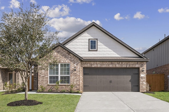1031 Rosewood Trl, Beasley, TX 77417 - view of front of home featuring brick siding, driveway, a garage, and a front yard