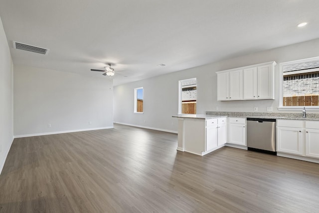 1031 Rosewood Trl, Beasley, TX 77417 - kitchen with dishwasher, ceiling fan, a peninsula, wood finished floors, and white cabinetry