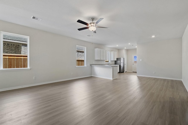 1031 Rosewood Trl, Beasley, TX 77417 - unfurnished living room with ceiling fan, wood finished floors, and recessed lighting