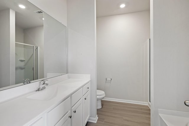 1031 Rosewood Trl, Beasley, TX 77417 - bathroom featuring a shower stall, wood finished floors, vanity, and recessed lighting