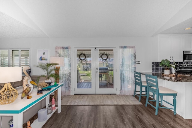 253 Barracuda St, Bayou Vista, TX 77563 - dining area with french doors, wood finished floors, and lofted ceiling