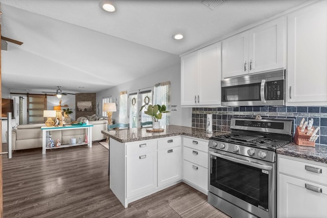 253 Barracuda St, Bayou Vista, TX 77563 - kitchen featuring stainless steel appliances, a peninsula, open floor plan, ceiling fan, and white cabinets