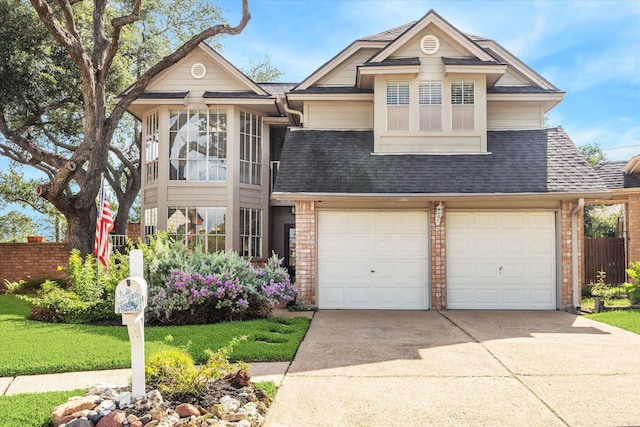 16063 Hidden Acres Dr, Houston, TX 77084 - view of front of property with driveway, a shingled roof, an attached garage, and brick siding
