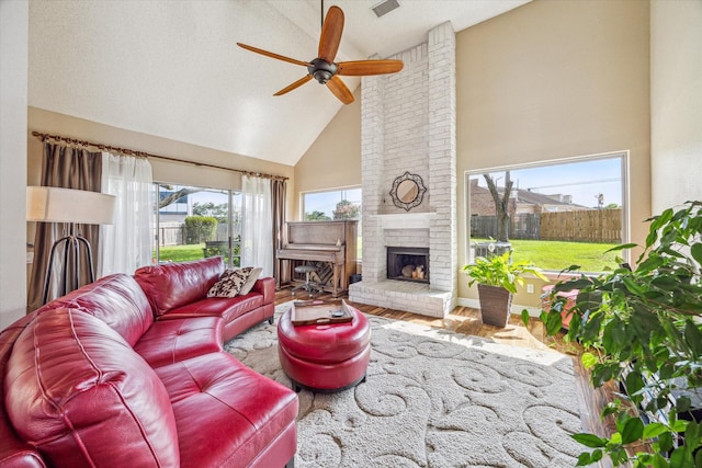 16063 Hidden Acres Dr, Houston, TX 77084 - living room with high vaulted ceiling, a ceiling fan, a fireplace, and wood finished floors