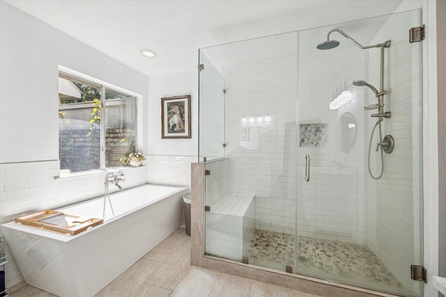 16063 Hidden Acres Dr, Houston, TX 77084 - full bath with a shower stall, a freestanding bath, tile walls, and tile patterned floors