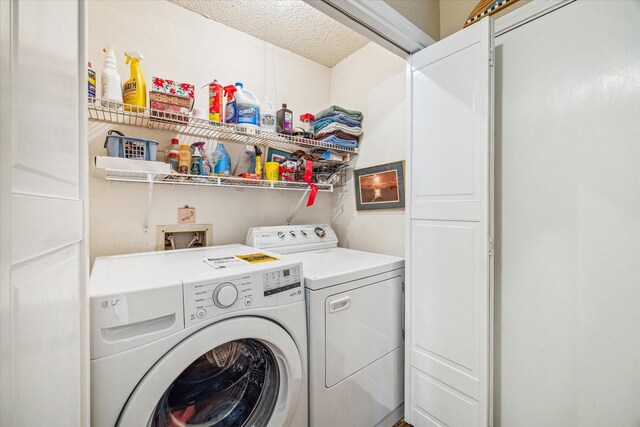 16063 Hidden Acres Dr, Houston, TX 77084 - laundry area with separate washer and dryer and a textured ceiling