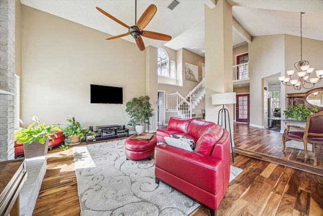 16063 Hidden Acres Dr, Houston, TX 77084 - living area with high vaulted ceiling, stairway, a chandelier, a ceiling fan, and hardwood / wood-style floors
