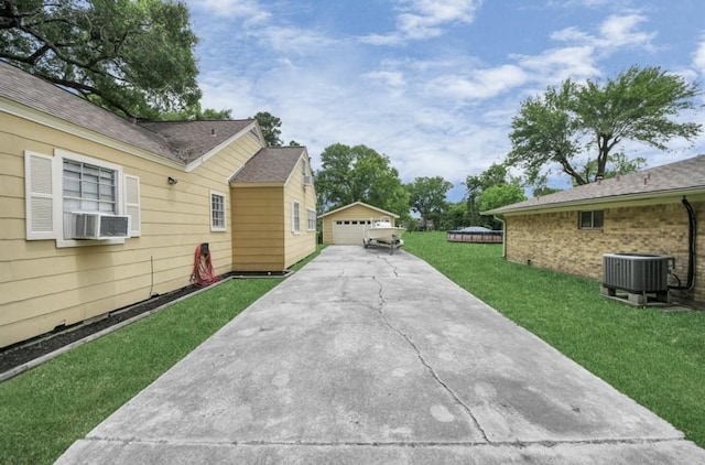 1800 Wright Blvd, Baytown, TX 77520 - view of grassy yard featuring a detached garage, an outbuilding, and cooling unit