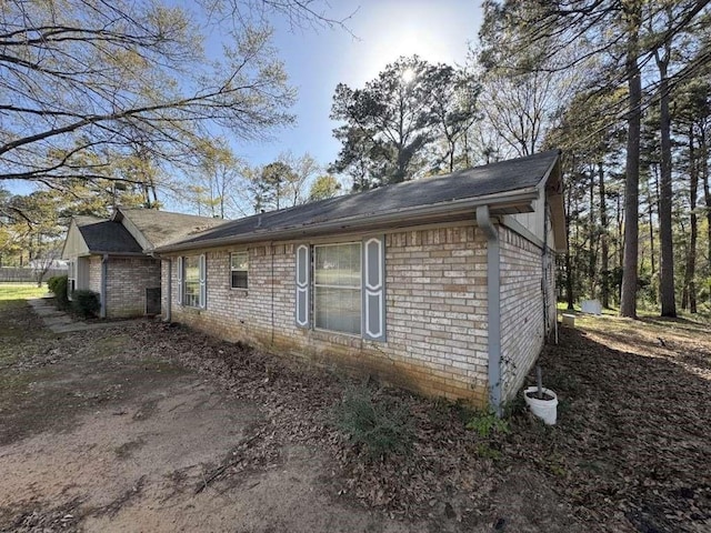 447 Plum Creek Rd, Longview, TX 75605 - view of side of property with brick siding and a shingled roof