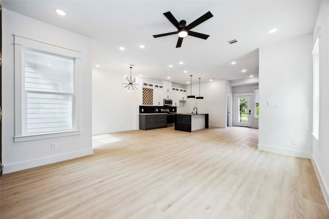 4601 Newberry St A/B, Unit A/B Houston, TX 77051 - unfurnished living room featuring light wood-style floors, ceiling fan, recessed lighting, and a chandelier