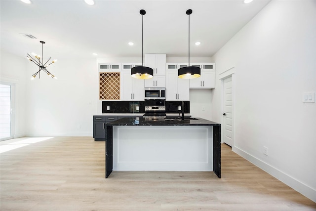 4601 Newberry St A/B, Unit A/B Houston, TX 77051 - kitchen featuring stainless steel appliances, white cabinetry, a chandelier, glass insert cabinets, and light wood finished floors
