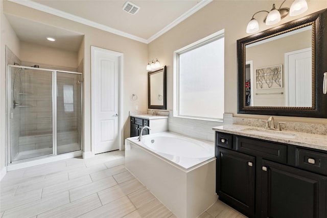 17522 Mineral Bluff Ln, Humble, TX 77346 - bathroom featuring a shower stall, two vanities, crown molding, and a bath