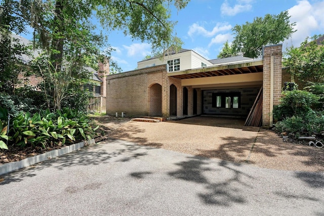 1 Woodstone St, Houston, TX 77024 - view of front of home with driveway and brick siding