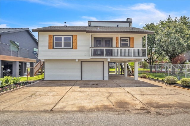 38 N Flamingo St, La Marque, TX 77568 - view of front facade with stairway, a porch, an attached garage, and driveway