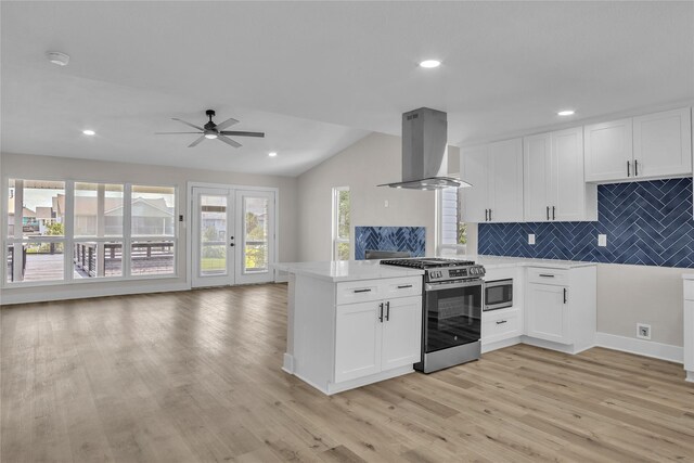 38 N Flamingo St, La Marque, TX 77568 - kitchen featuring island exhaust hood, stainless steel appliances, open floor plan, a peninsula, and light countertops
