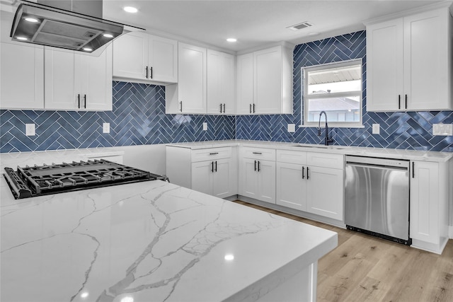 38 N Flamingo St, La Marque, TX 77568 - kitchen with dishwasher, range hood, decorative backsplash, cooktop, and light stone countertops