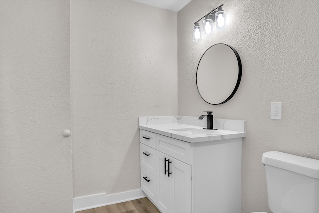38 N Flamingo St, La Marque, TX 77568 - half bath featuring vanity, wood finished floors, and a textured wall