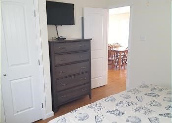 1314 Seashell Dr, Surfside Beach, TX 77541 - bedroom featuring dark wood-style floors