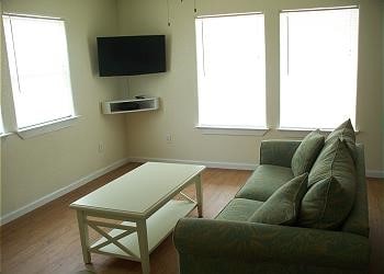 1314 Seashell Dr, Surfside Beach, TX 77541 - living area featuring wood finished floors and plenty of natural light