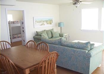 1314 Seashell Dr, Surfside Beach, TX 77541 - dining space with ceiling fan, healthy amount of natural light, and wood finished floors