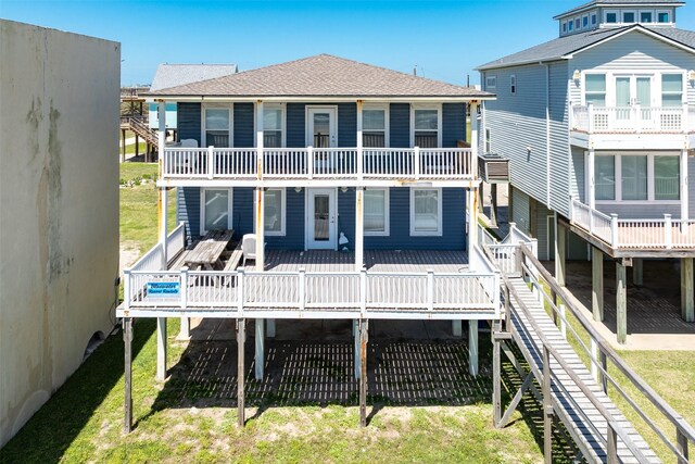 115 Southwind Dr, Surfside Beach, TX 77541 - back of house with roof with shingles, a deck, a balcony, and a yard